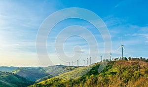 Clean and renewable energy to reduce carbon emissions concept, several wind turbines generating electricity on the mountain, sky