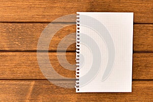 Clean sheet of paper on wooden background . Concept