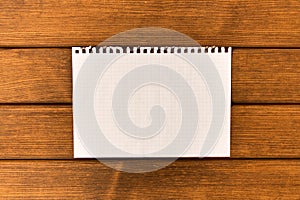 Clean sheet of paper on wooden background . Concept