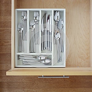 Clean silverware utensils in kitchen drawer. Neat, tidy, organized home kitchen storage