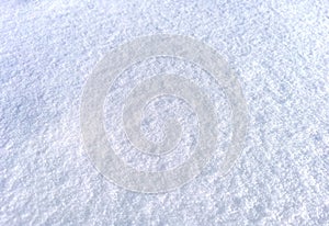 Clean snow surface in sun light, blue white texture with visible snowflakes. Natural winter frozen background