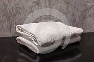 A clean stack of white folded towels