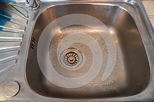 clean stainless wash basin in kitchen at home