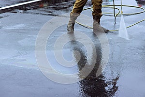 Clean a street sprayed with pressurized water, wet washing cleaning