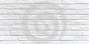 A clean, textured white brick wall, perfect for background use in various design and photography projects