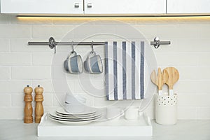 Clean towel, utensils and dishware in kitchen