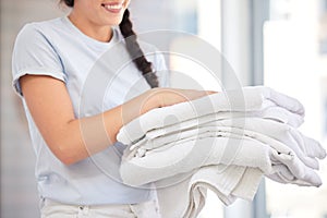 Clean towels, laundry and woman doing washing while working for cleaning service, hospitality and housekeeping industry