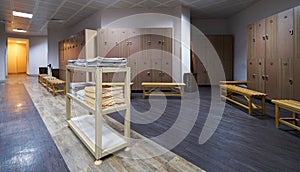 Clean towels shelf in a locker room with wooden benches in luxur