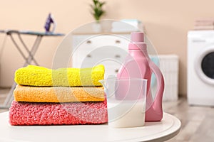 Clean towels and softener on table