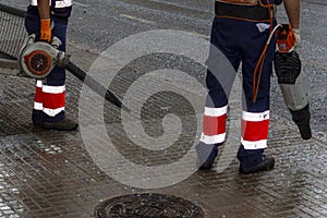 clean-up brigade removing confetti after the parade in the street