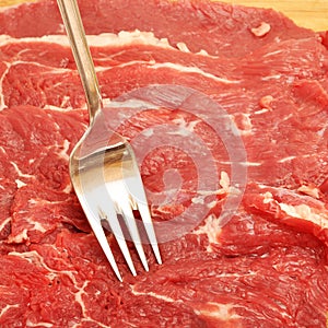 Clean very fresh red raw meat beef and fork, cow meat texture
