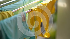 Clean washed clothes are dried in metal dryer closeup