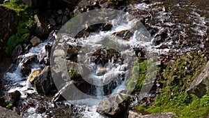 Clean Water Flowing Through The Rocks In A Small Waterfall At The Mountain In Manali, Himachal Pradesh - close up slowmo