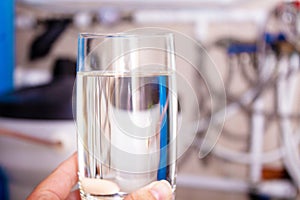 Clean water glass in hand. Water softening.