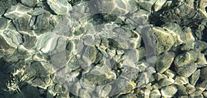 Clean water  and stones and sun rays