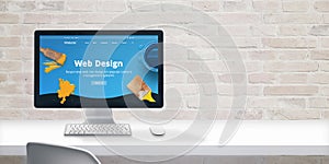 Clean web designer desk with computer display and modern flat design web site teme with web design text