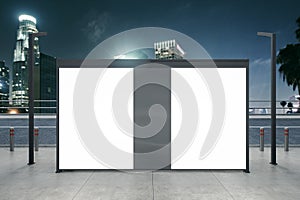 Clean white bus stop billboard on night city background. Commercial and ad concept. Mock up, 3D Rendering