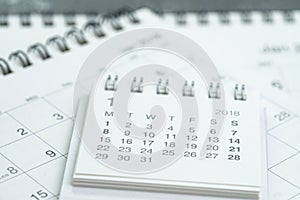 Clean white calendar business deadline, time passing, year planning or appointment reminder concept by pile of white and clean pa