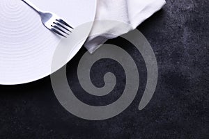 Clean white plate, fork and napkin