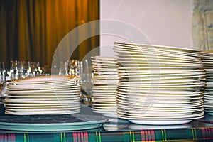 Clean white plates stacked on table