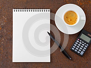 Clean white sheet in an open spiral-bound pad, pen, calculator a