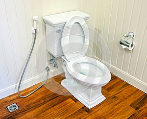 Clean, white and sterile toilet in a white wall bathroom.