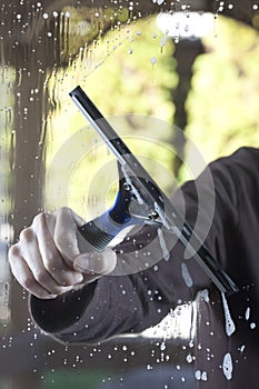 Clean window with squeegee photo