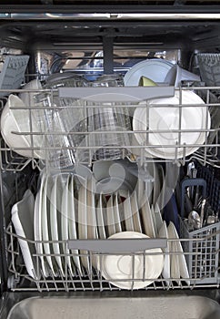 Cleaned dishware in dishwasher background