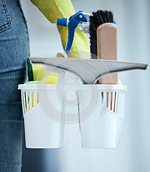 Cleaner, basket and cleaning supplies at home with detergent for hygiene or safety from bacteria or germs. Housekeeper