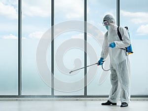 Cleaner man use sterilize spray on company office floor by chemicals sanitizer backpack equipment and wear face mask, transparent