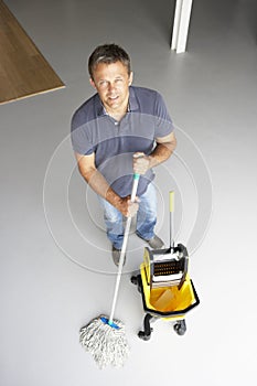 Cleaner mopping office floor