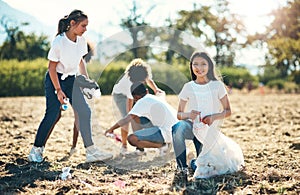 The cleaner the park, the more we can play. a group of teenagers picking up litter off a field at summer camp.
