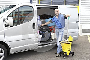 Cleaner standing next to van photo