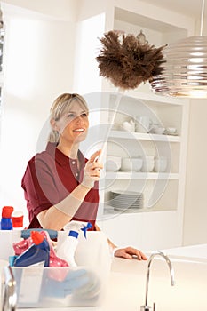 Cleaner Working In Domestic Kitchen