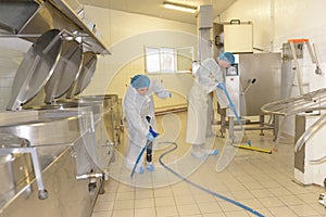 Cleaners cleaning industrial kitchen floor