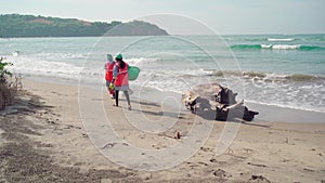 Cleaners establish order on seacoast from garbage. Workers make clean sandy beach for comfortable