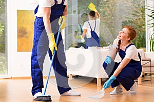 Cleaners sweeping floor