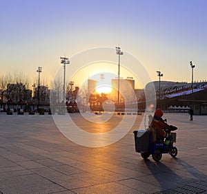 Cleaners work at beijing olympic sports center plaza at sunrise, adobe rgb
