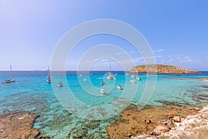 The cleanest turquoise sea off the coast Cala Escondida. Ibiza, Balearic Islands. Spain photo