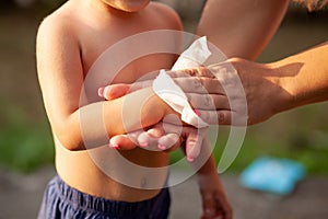 Cleaning baby hands with wet wipes tissue