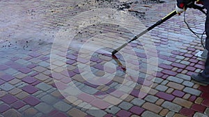 Cleaning backyard paving tiles with high pressure washer. Spring clean up. slow motion