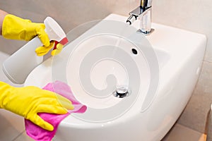 Cleaning bidet in wc with pink cloth.