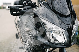 Cleaning black touristic motorbike