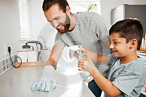 Cleaning, bonding and caucasian father and son working together to keep the home tidy. Chores, learning and a happy