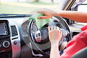 Cleaning the car interior with green microfiber cloth photo