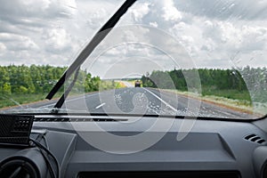 Cleaning the car`s windshield with a windscreen wiper