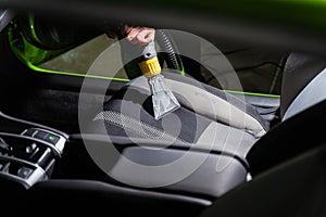 Cleaning car salon dry cleaning with vacuum cleaner. Professional use of a steam vacuum cleaner to remove stains.