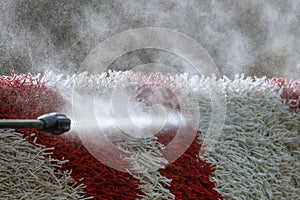 Cleaning the carpet with a gun for washing high pressure water. House cleaning