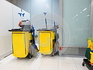 Cleaning Cart in the station. Cleaning tools cart and Yellow mop bucket wait for cleaning.Bucket and set of cleaning equipment