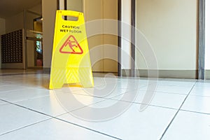 Cleaning and caution wet flooring signboard on the floor